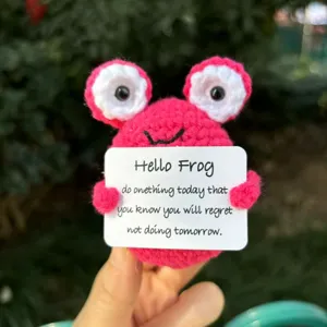 Handmade crochet pink frog plush doll toy with motivational quote card for cute desktop decor.
