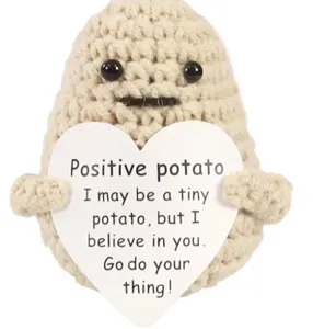 Handmade crochet potato doll closeup featuring cute facial expression and inspiring heart card.
