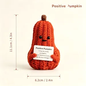 Crochet pumpkin doll detail view showing cute facial expression, encouraging card, and size specs.