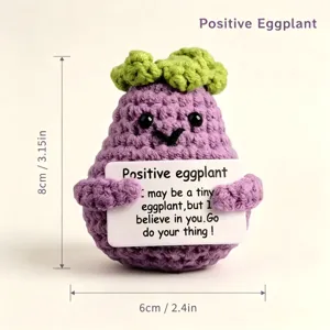 Detailed shot of a cute handmade crochet eggplant plush toy holding an inspiring card, 8cm.