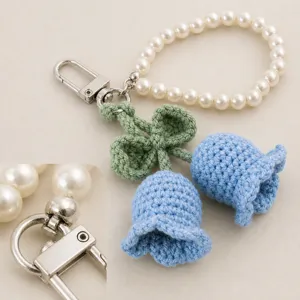 Close-up detail shot of handmade crochet lily of the valley flowers with fine stitches and pearl strap.