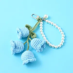Crochet lily of the valley keychain with pearl strap blue handmade bag charm accessory.