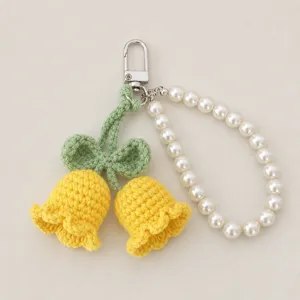 Handcrafted crochet lily of the valley keychain detail, cute floral bag charm with pearls.