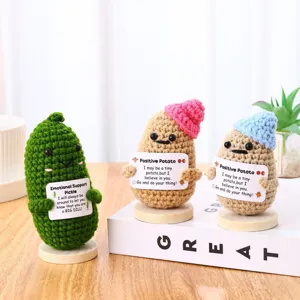 Handmade crochet positive potato and emotional support pickle dolls with cute signs for desk decor.
