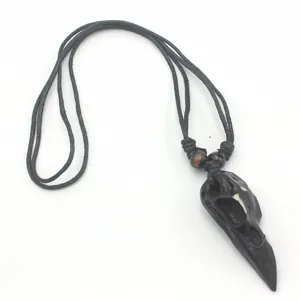 Retro punk style raven bird skull resin pendant necklace with black cord and wooden beads.