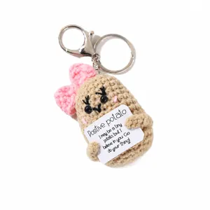 Handcrafted crochet potato doll keychain with pink bow and cute positive message card.