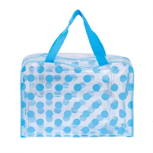 Borsa da toeletta trasparente in PVC a pois blu con manici, ideale come beauty case da viaggio.