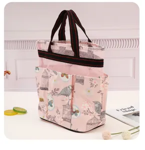 Detail view of the pink portable mesh storage bag, featuring multi pockets and durable handles.