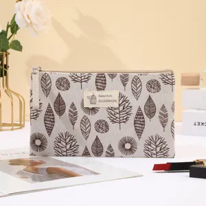 Canvas cosmetic bag with leaf print, portable zipper storage pouch for travel and daily use.