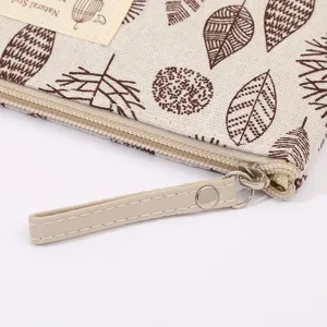 Fabric cosmetic bag zipper detail showing leaf pattern and smooth metallic pull tab.