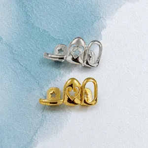 Close-up detail of hip-hop grills teeth jewelry, silver and gold spliced hollow star heart design.