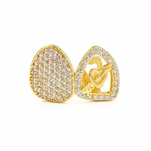 Gold plated hip hop teeth grillz detail, iced out cubic zirconia stone double tooth cap.