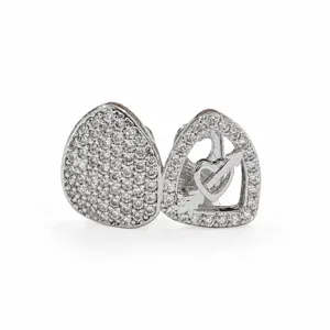 Hip hop grillz detail shot featuring double tooth design with cubic zirconia and heart arrow.