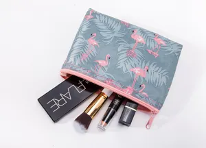 Detail view of the flamingo print cosmetic bag, featuring waterproof fabric and zipper.