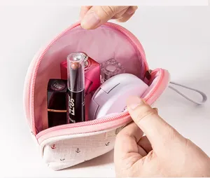 Detail view of canvas anchor makeup pouch, open with cosmetics inside, convenient storage.