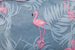 Detail view of portable cosmetic bag with pink flamingo and tropical leaf print pattern on fabric.