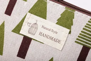 Close-up detail van canvas cosmetische pouch stof textuur boom print en handgemaakt label.