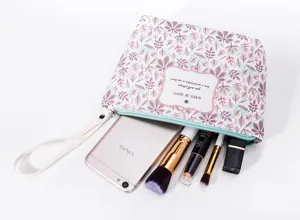 Floral print cosmetic bag with zipper and handle, ideal for organizing makeup daily.