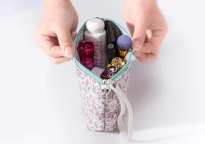 Detailed view of cosmetic pouch interior showing large capacity with botanical leaf print design.