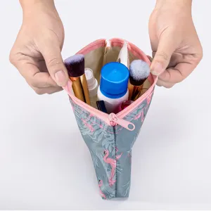 Portable waterproof travel makeup bag with cute flamingo print, perfect toiletry organizer pouch.