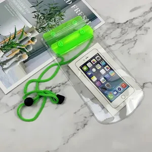 Clear waterproof phone pouch with green sealing clip and lanyard for beach outdoor sports use