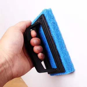 Close-up view of the handheld blue sponge cleaning brush with black handle for grooves.