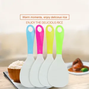 Close-up detail of colorful non-stick rice paddle with hanging hole, convenient kitchen tool.