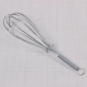 Stainless steel wire whisk detail, durable kitchen baking tool with ergonomic spiral handle.