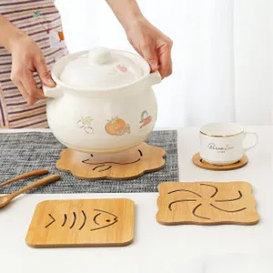 Wooden heat insulation pad set with ceramic soup pot for kitchen dining table decor details.