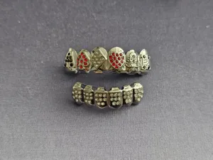 Poker teeth grillz with sparkling rhinestones, detailed close-up shot of hip hop rapper jewelry.