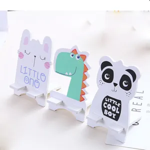 Cute wooden cartoon animal phone stand detail shot, creative desktop storage bracket for office.