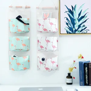 Wall-mounted hanging storage bag with cute flamingo print, multi-pocket organizer for home.