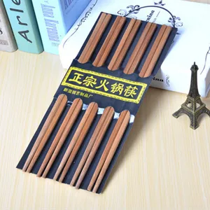 Detailed view of traditional wooden chopsticks set in neat black holder package for daily dining.