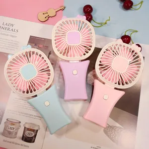 Portable cute mini handheld fan with cartoon cat ears for summer cooling and outdoor daily use.
