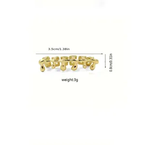 Detail view of golden hip hop grillz teeth, shining polished surface and unique style.