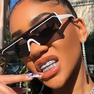 Close-up detail of luxury hip hop grillz sparkling with zircon stones, trendy fashion street style.