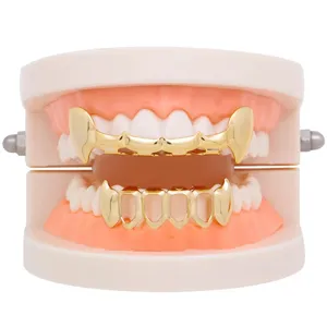 Detailed view of gold hip-hop vampire fangs grillz set, glossy hollow teeth accessory.