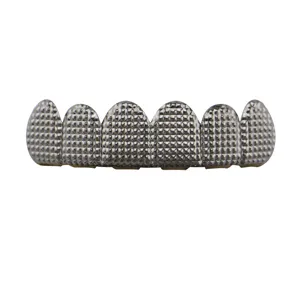 Detailed closeup of hip hop silver grillz featuring a unique textured grid design for men.