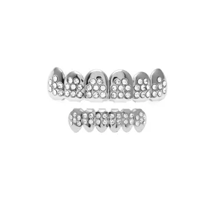 Close-up detail of silver tone hip hop rhinestone teeth grillz set, sparkling crystal grill decor.