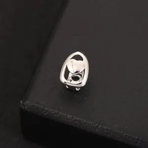 Hip hop silver tooth grillz detail shot, shiny metal denture prop for stage and party wear.
