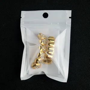 Detailed view of trendy hip hop gold teeth grillz featuring sparkling rhinestone heart designs.