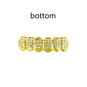 Detail shot of golden hip hop grillz featuring sparkling rhinestone inlay, bottom teeth.
