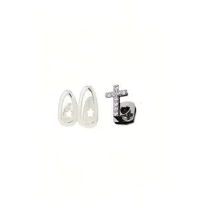 Hip hop tooth grillz set with cubic zirconia cross and star hollow design details.