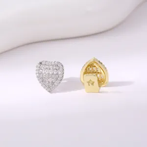 Detail shot of heart shaped grillz tooth jewelry showing dazzling rhinestones and shiny gold back.