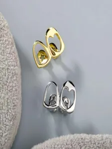 Close-up of stylish hollow heart star grillz in gold and silver, cool hip-hop dental jewelry.