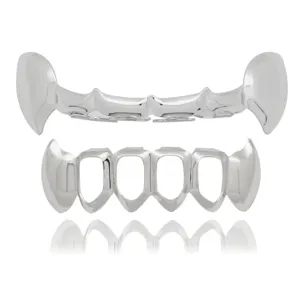Detailed close-up view of hip-hop silver grillz, glossy cutout vampire fangs teeth set.