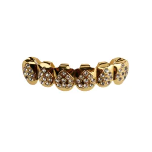 Gold hip hop grillz close up, sparkling rhinestone tooth caps, trendy streetwear dental jewelry.