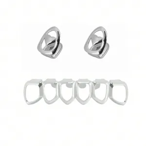 Close-up detail of silver hip hop grillz set featuring heart cutout caps and six tooth grill.