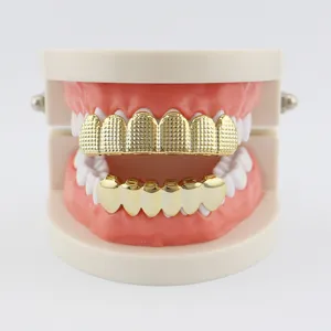 Close-up details of the hip-hop gold grillz, featuring textured upper and smooth lower teeth.
