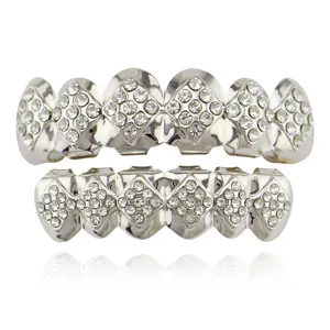 Detailed view of silver-plated hip-hop teeth grills sparkling with rhinestones, elegant close-up.
